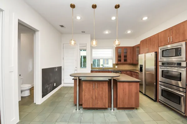 a kitchen with a sink refrigerator and microwave