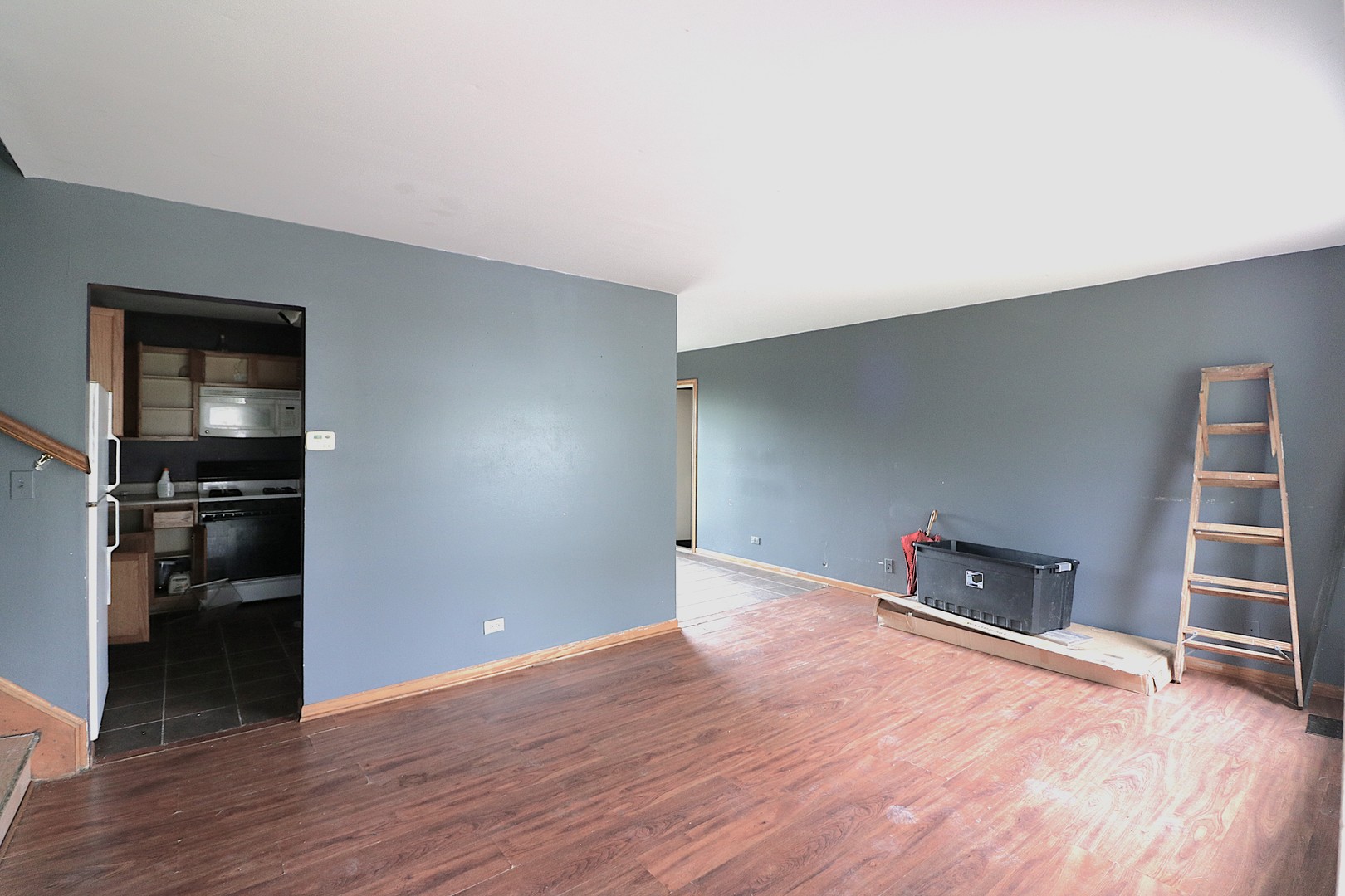 319 Dean Circle Bolingbrook, IL 60440 - Photo 2 of 11 a view of empty room with wooden floor and kitchen