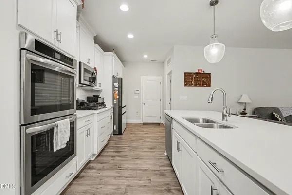 a kitchen with stainless steel appliances granite countertop a sink and stove top oven