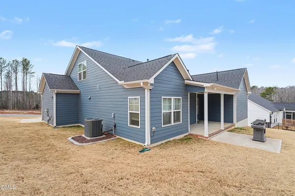 a view of a house with wooden fence
