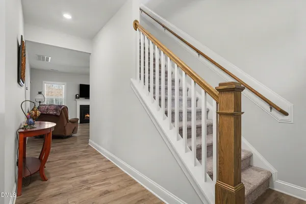 a view of entryway and hall with wooden floor