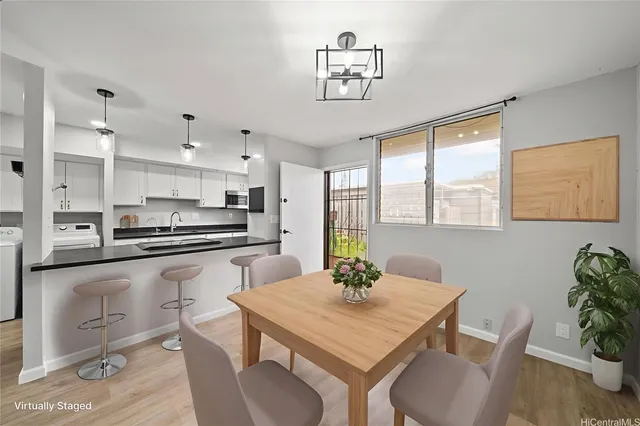 a kitchen with a table chairs microwave and cabinets