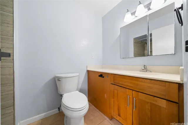 a bathroom with a sink a toilet and mirror