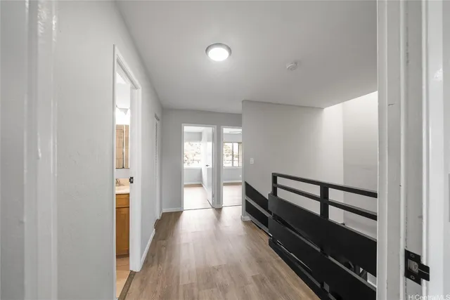 a view of hallway with wooden floor