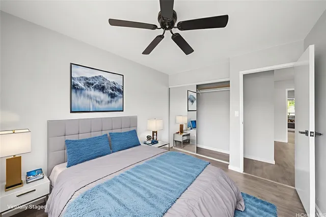 a bedroom with a bed and a painting on the wall