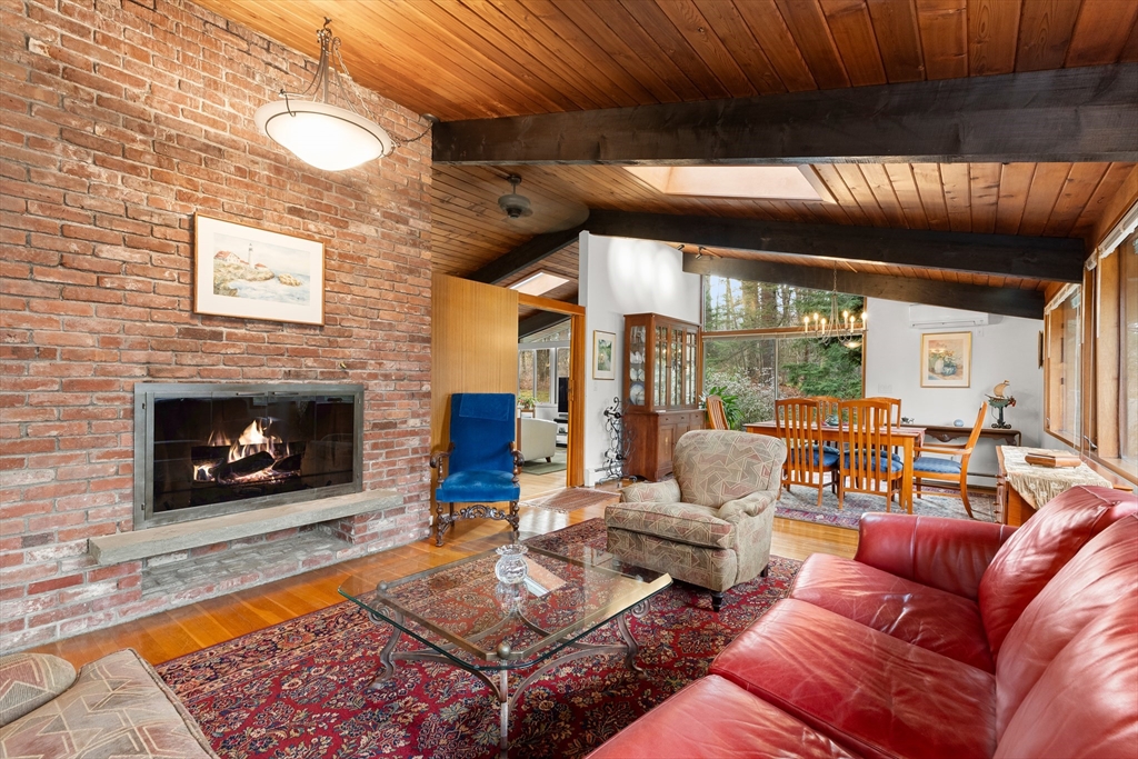 76 Hillside Road North Andover, MA 01845 - Photo 14 of 42 a living room with furniture a fireplace and a table