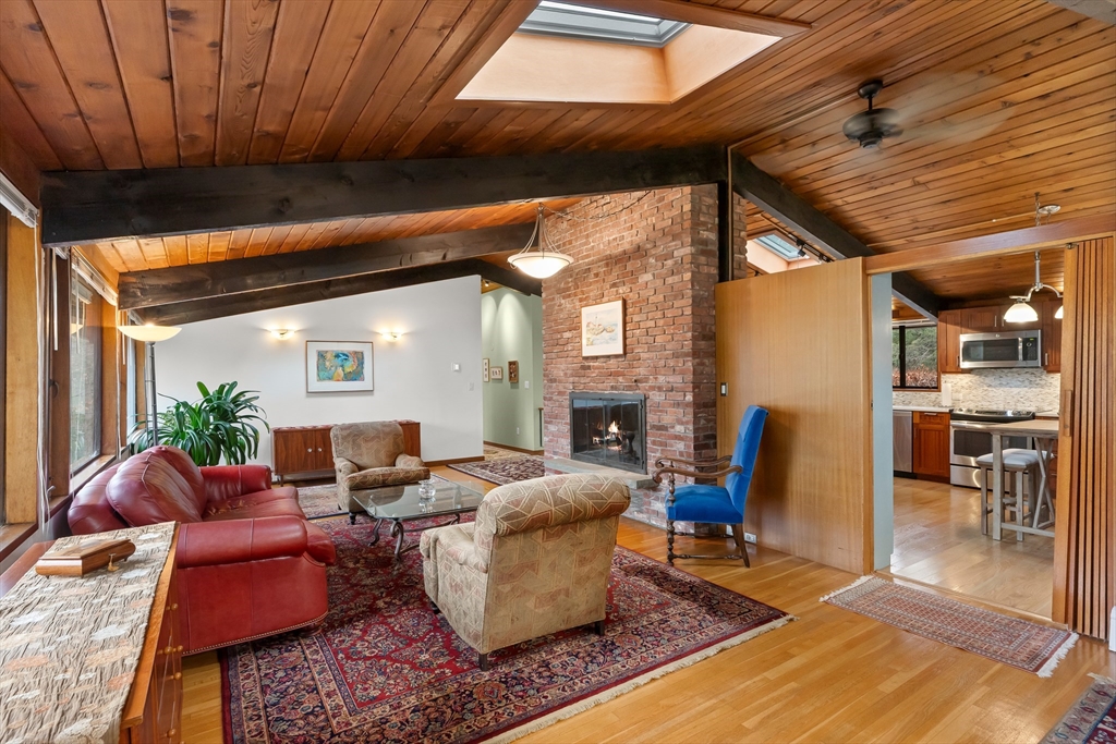 76 Hillside Road North Andover, MA 01845 - Photo 16 of 42 a living room with furniture a fireplace and a table