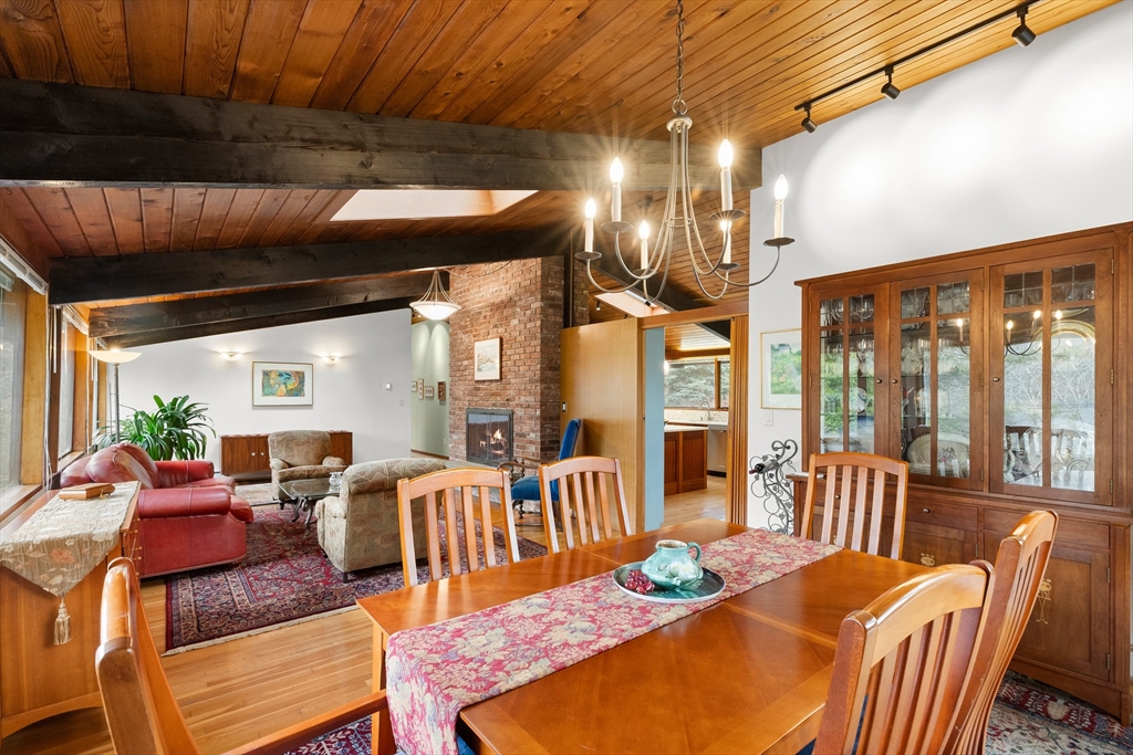 76 Hillside Road North Andover, MA 01845 - Photo 17 of 42 a view of a dining room with furniture large windows and wooden floor