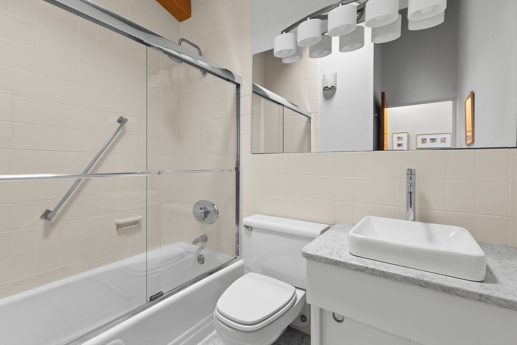 76 Hillside Road North Andover, MA 01845 - Photo 25 of 42 a white toilet sitting next to a bath tub