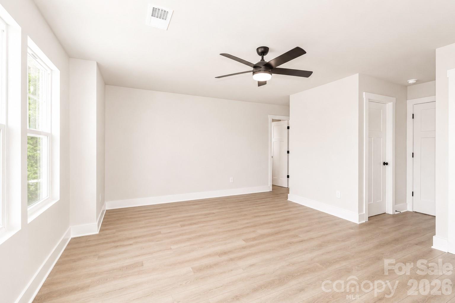 237 3rd Creek Road Stony Point, NC 28678 - Photo 17 of 29 a view of a big room with wooden floor closet and windows