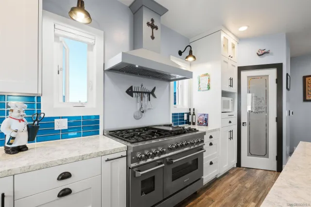 a kitchen with stainless steel appliances a stove and a refrigerator