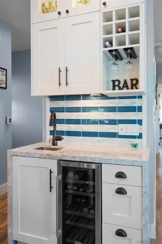 a view of cabinets a oven and a stove with white cabinets