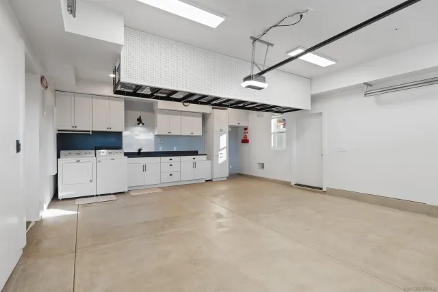 a view of a utility room with cabinets