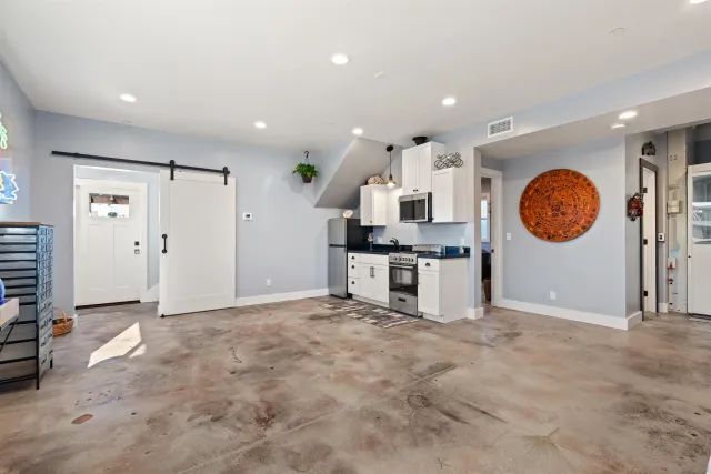 a kitchen with stainless steel appliances granite countertop a stove a sink and a cabinets