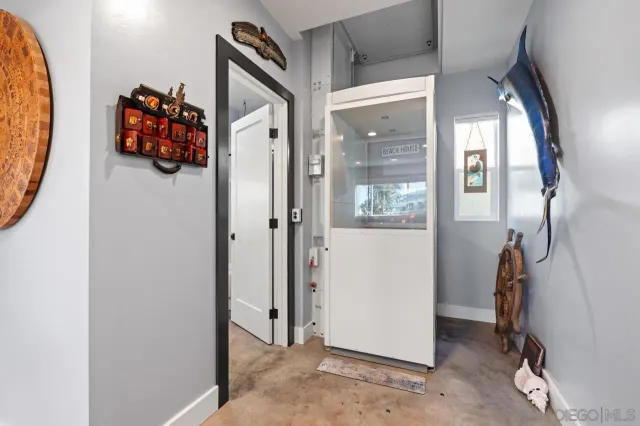 a view of a hallway with wooden floor and windows