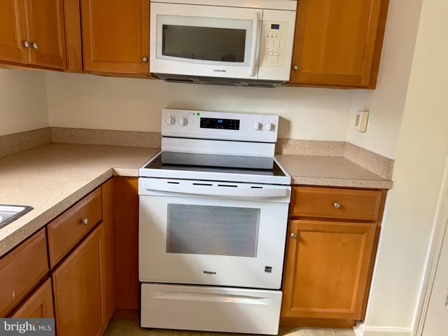 a kitchen with microwave cabinets and a sink