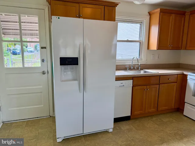 a utility room with cabinets washer and dryer