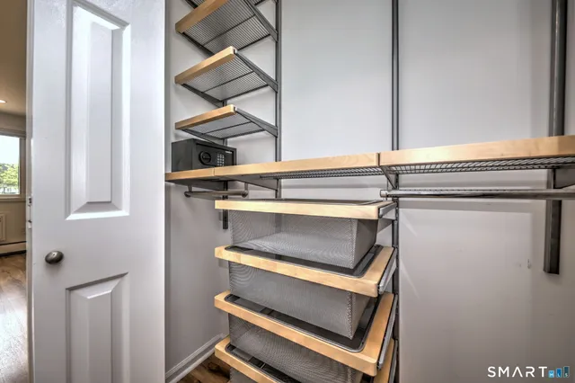 a view of a room with rack and a window