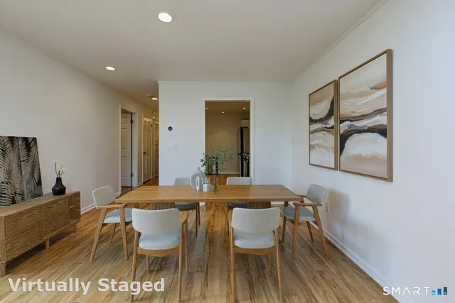 a view of a dining room with furniture and wooden floor