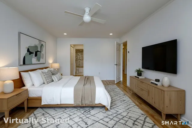 a bedroom with a bed and a flat screen television