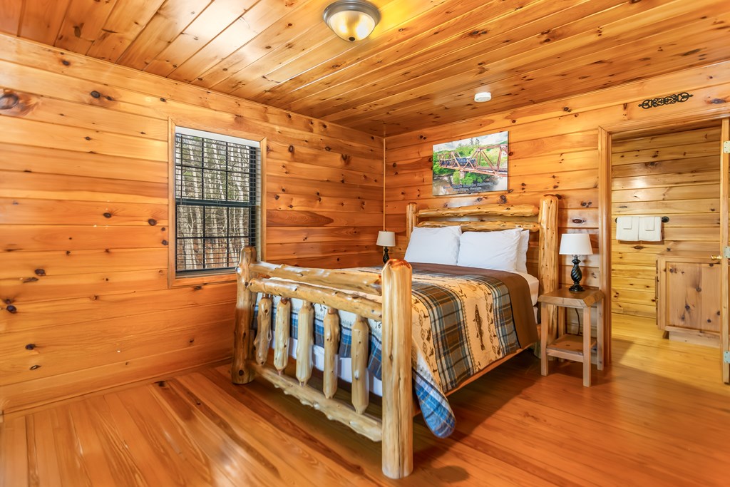 249 Sugar Mountain Road Blue Ridge, GA 30513 - Photo 23 of 61 a bedroom with a bed and wooden floor