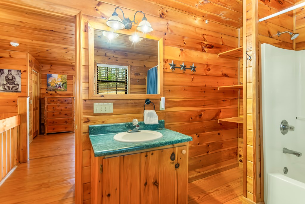 249 Sugar Mountain Road Blue Ridge, GA 30513 - Photo 26 of 61 a bathroom with a granite countertop window and a shower