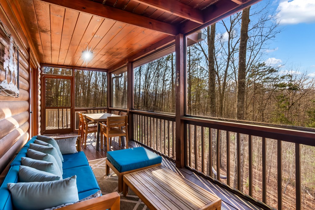 249 Sugar Mountain Road Blue Ridge, GA 30513 - Photo 31 of 61 a view of a patio with couches chairs and wooden floor