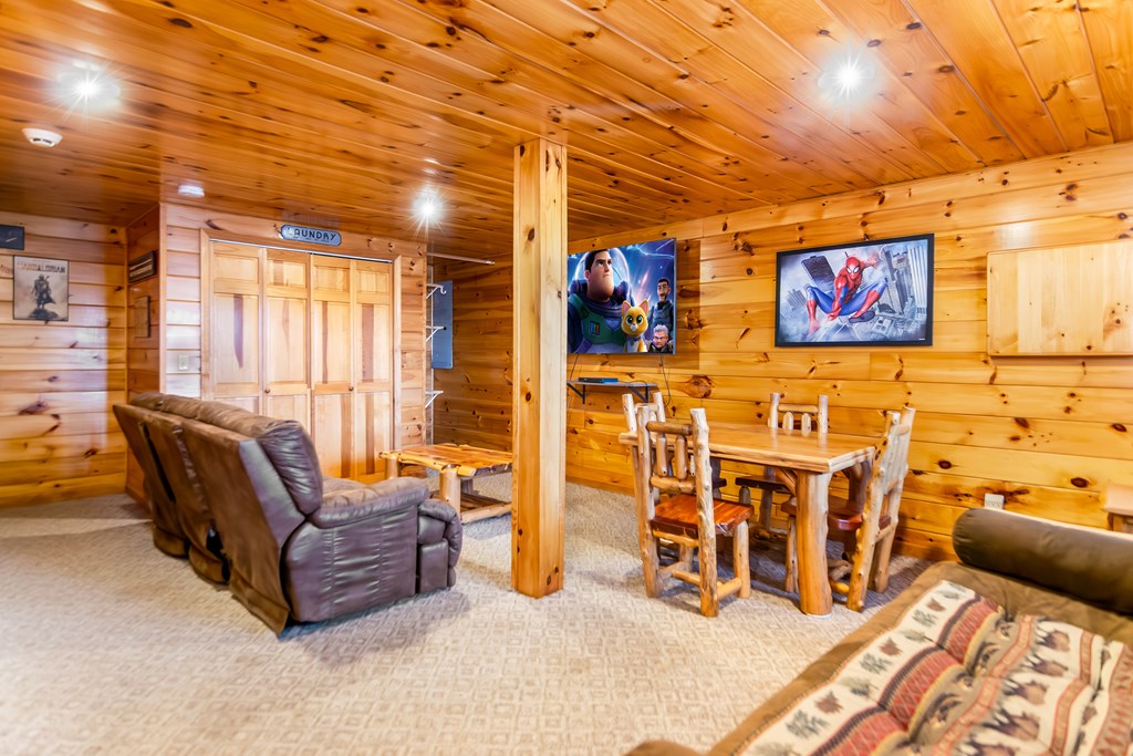 249 Sugar Mountain Road Blue Ridge, GA 30513 - Photo 36 of 61 a living room with furniture and a flat screen tv