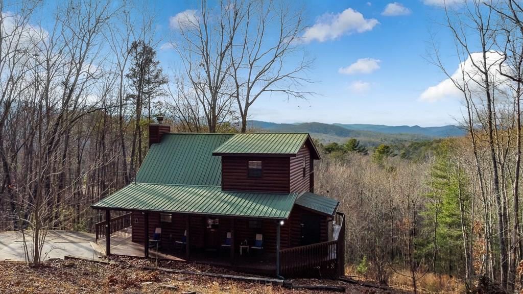 249 Sugar Mountain Road Blue Ridge, GA 30513 - Photo 59 of 61 a view of a yard with large trees and wooden fence