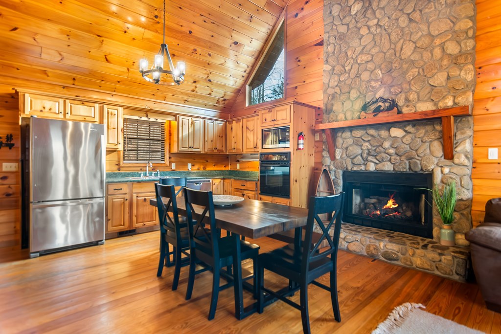 249 Sugar Mountain Road Blue Ridge, GA 30513 - Photo 6 of 61 a dining room with furniture and a fireplace