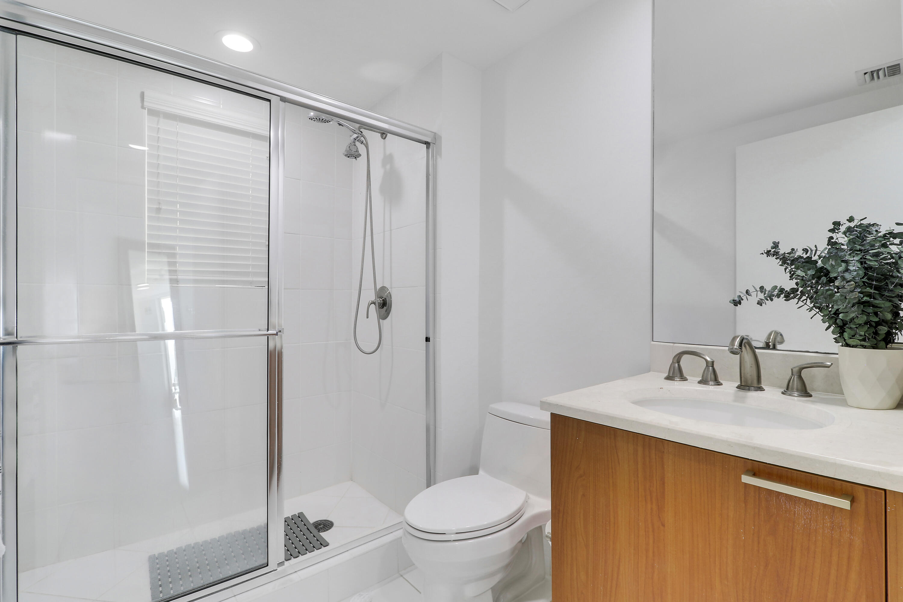 2640 Lake Shore Drive, Unit 307 Riviera Beach, FL 33404 - Photo 35 of 44 a bathroom with a shower toilet and sink