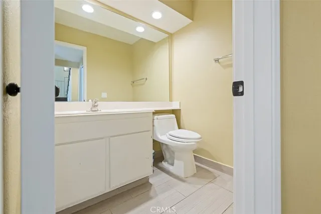 a bathroom with a sink toilet and mirror