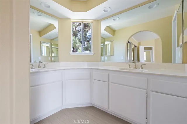 a bathroom with a granite countertop sink a large mirror and a window