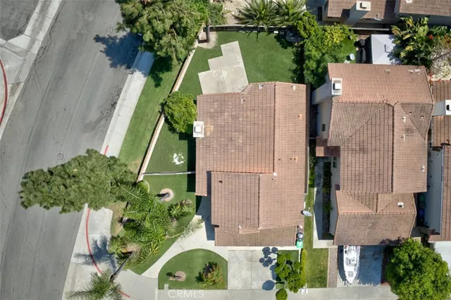 an aerial view of a house with a yard