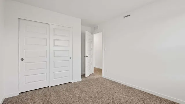 an empty room with closet area