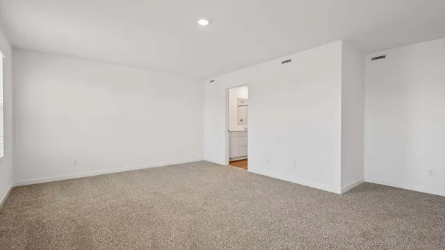 a view of an empty room and a window