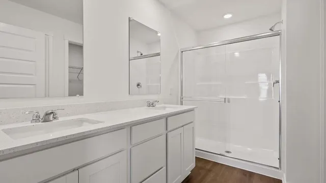 a bathroom with a glass shower door
