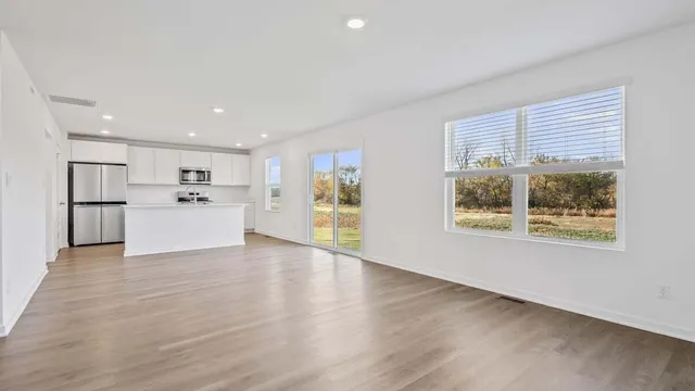 a view of a kitchen with a sink a refrigerator and window