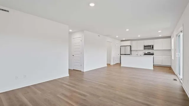 a view of a kitchen with a sink and a refrigerator