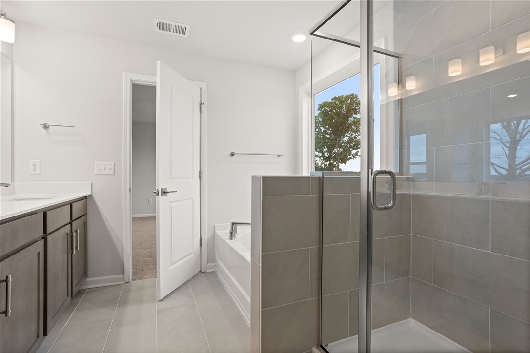 631 Sweetspire Trail, Unit 148 Seneca, SC 29678 - Photo 29 of 36 A well-appointed bathroom with a spacious glass-enclosed shower and a modern vanity.