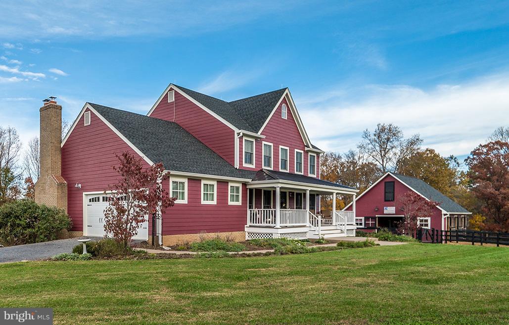 9692 Ridge View Drive Marshall, VA 20115 - Photo 1 of 26 a front view of a house with a garden