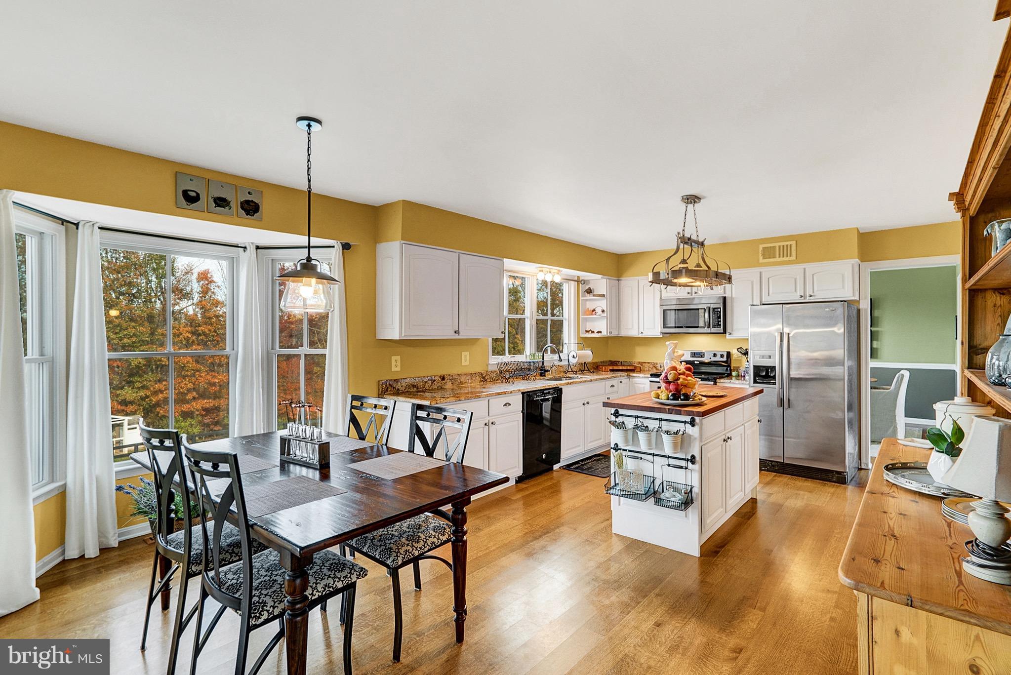 9692 Ridge View Drive Marshall, VA 20115 - Photo 6 of 26 a open kitchen with stainless steel appliances kitchen island granite countertop a table chairs and a stove