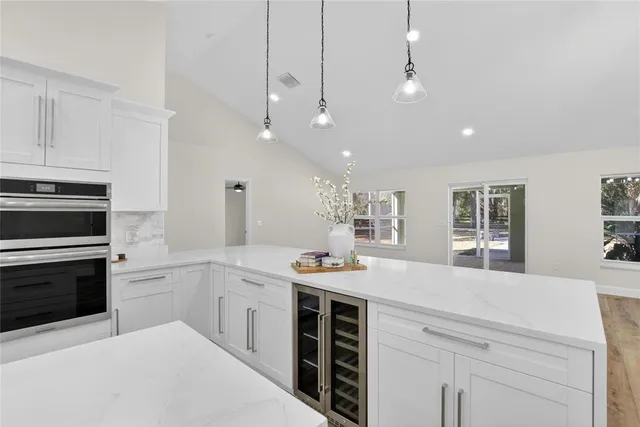 a view of a room with wooden floor and a ceiling fan