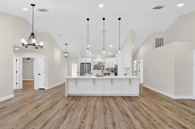a bathroom with a sink a light fixture and a mirror