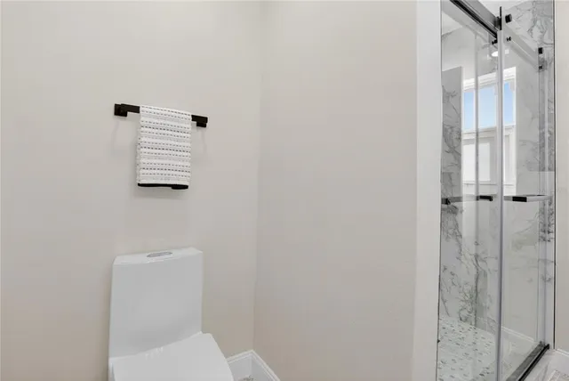 an empty room with wooden floor and ceiling fan