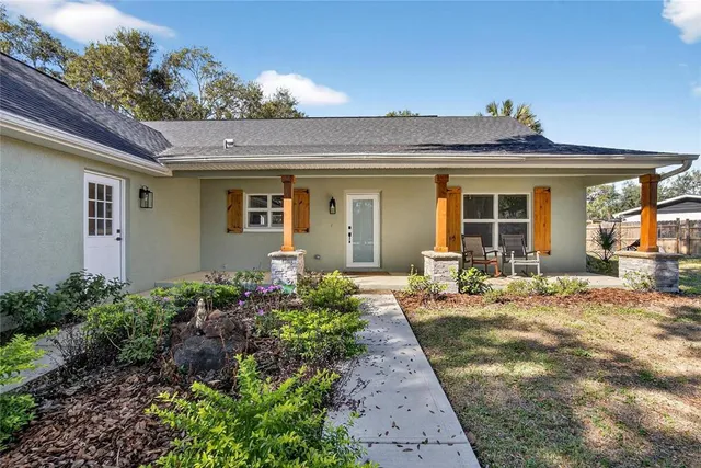 a kitchen with a refrigerator a sink and dishwasher with wooden floor