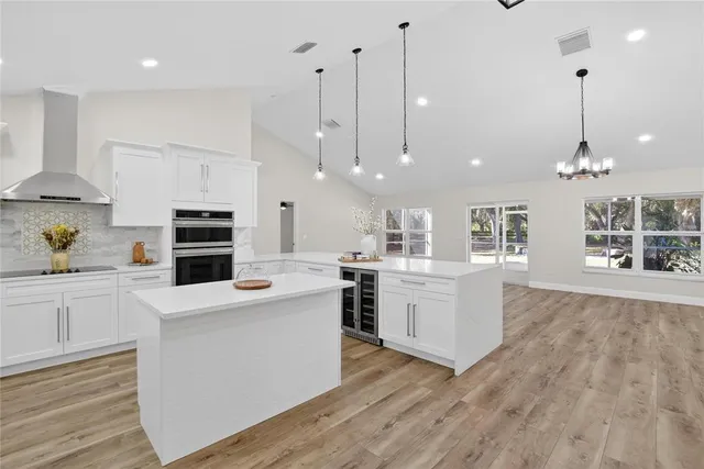 a kitchen with kitchen island a stove a sink and a refrigerator
