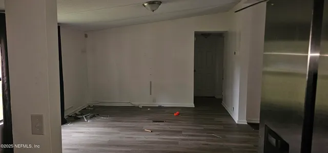 a view of room with wooden floor