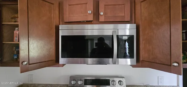 a kitchen with granite countertop a refrigerator and a stove