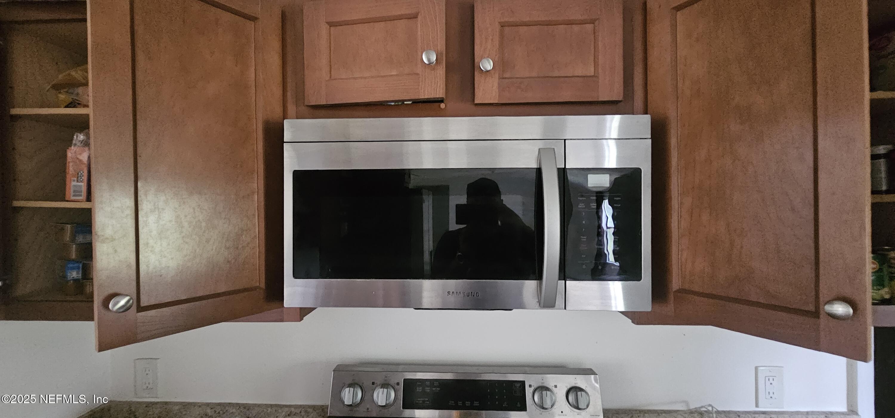 5951 Westwood Road North Jacksonville, FL 32234 - Photo 16 of 33 a kitchen with granite countertop a refrigerator and a stove